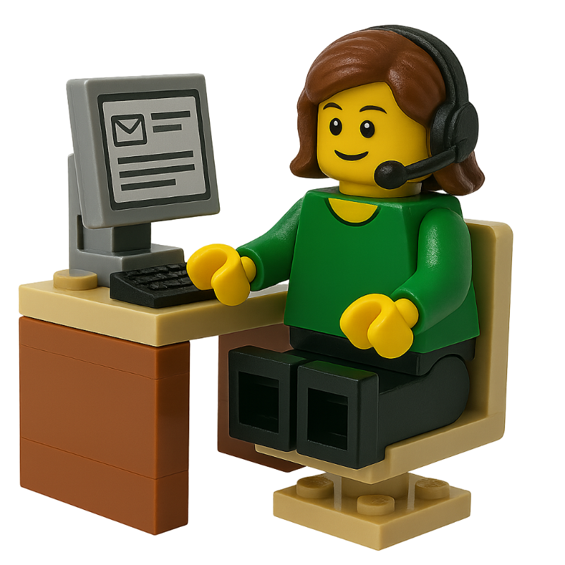 LEGO minifigure of a person at a computer desk with a headset on in front of a computer